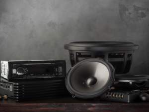 Car audio speaker in front of in front of subwoofers and other accessories